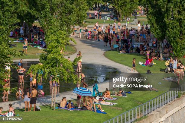 People cool off in the water jets of the urban beach of Madrid Rio. A second heat wave in the summer affects the entire Iberian Peninsula, according...