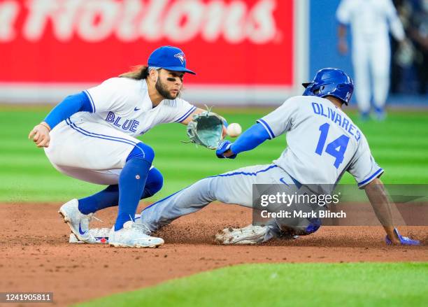 Edward Olivares of the Kansas City Royals is out trying to steal second base against Bo Bichette of the Toronto Blue Jays in the third inning during...