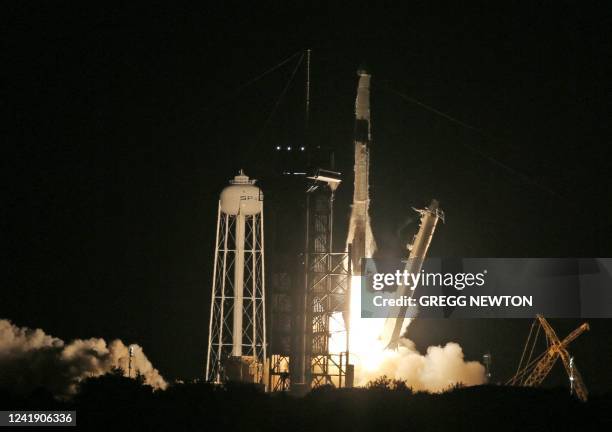 SpaceX Falcon 9 rocket streaks toward space on the CRS-25 mission after lifting off from pad LC-39A at the Kennedy Space Center in Florida on July...