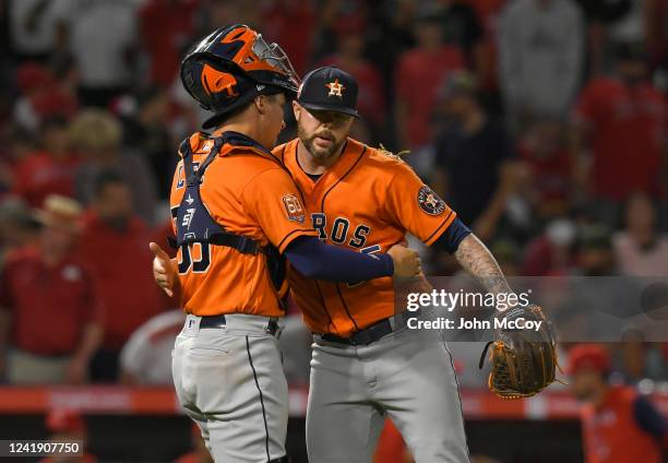 Ryan Pressly and Korey Lee of the Houston Astros celebrate a 3-2 win over the Los Angeles Angels in 10 innings at Angel Stadium of Anaheim on July...