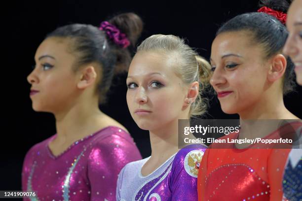 Daria Spiridonova of Russia lines up between the Downie sisters from Great Britain before the women's uneven bars apparatus final during the European...