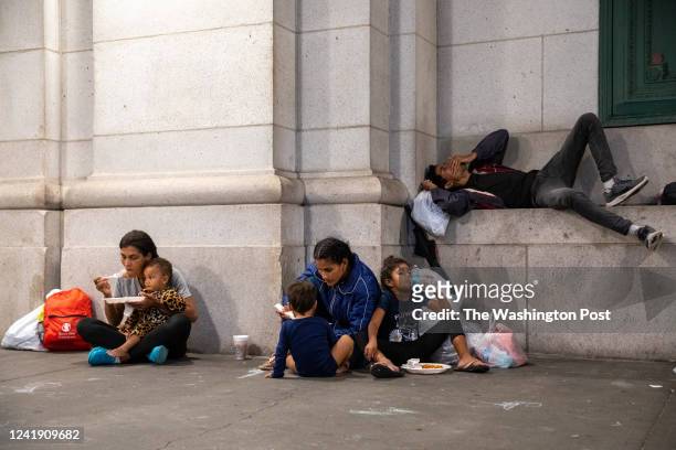 Families and solo migrants have a meal together after arriving at Union Station in Washington, D.C. On July 12 following a bus ride that originated...