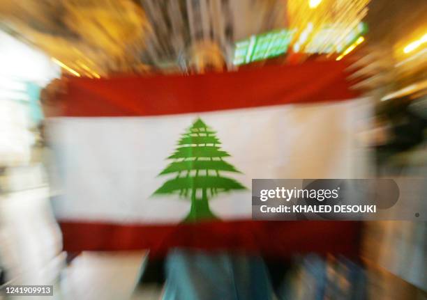 An Egyptian holds a Lebanese flag during a protest in downtown Cairo 30 July 2006, against the Israeli offensives against Lebanon and Gaza. An...