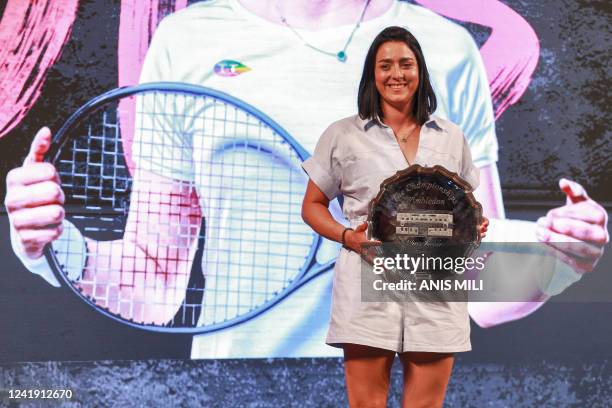 Tunisian tennis player Ons Jabeur poses with her second place Wimbledon trophy during a ceremony honouring her at the Municipal Theatre in the Avenue...