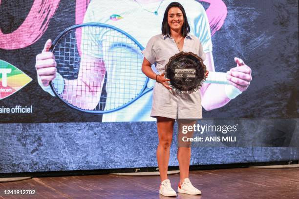 Tunisian tennis player Ons Jabeur poses with her second place Wimbledon trophy during a ceremony honouring her at the Municipal Theatre in the Avenue...