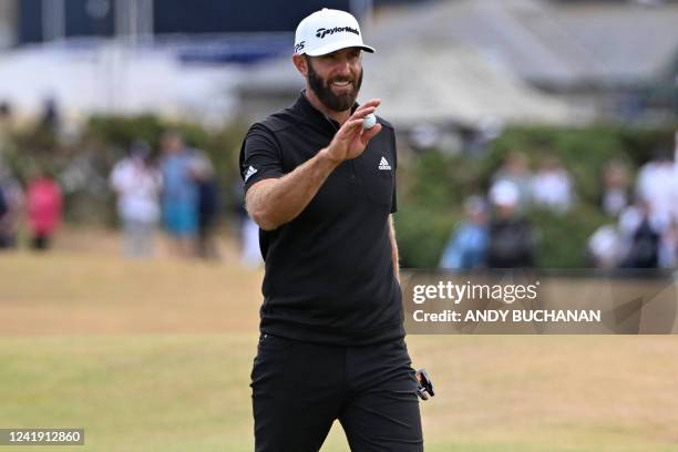 Golfer Dustin Johnson reacts to making his birdie putt on the 16th green to tie the lead during his second round on the day 2 of The 150th British...