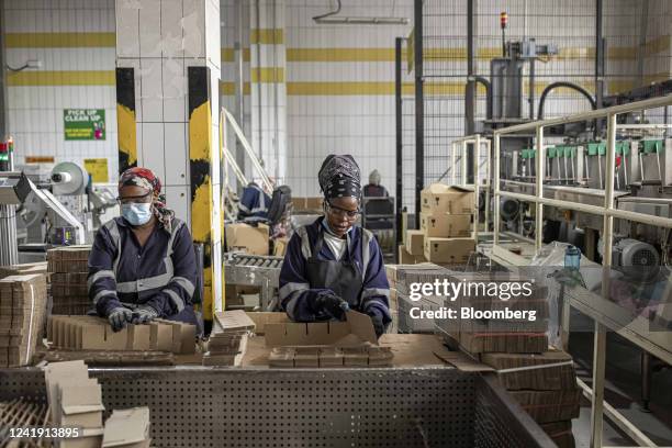 Workers assemble boxes on the packaging line at the Kenya Breweries Ltd. Bottling plant, operated by East Africa Breweries Ltd., in Nairobi, Kenya,...
