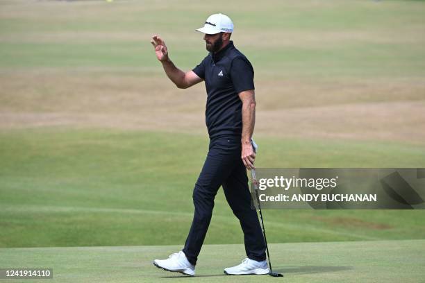 Golfer Dustin Johnson reacts after making a birdie putt on the 18th green during his second round on the day 2 of The 150th British Open Golf...