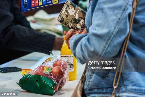 Customer prepares to pay for shopping at the check-out till inside a Spar Group Ltd. Supermarket in the Die Wilgers suburb of Pretoria, South Africa,...