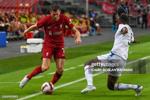 Crystal Palace's English defender Tyrick Mitchell challenges Liverpool's English midfielder James Milner for the ball during the exhibition football...