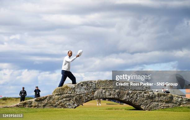 Tiger Woods of the United States acknowledges the crowd as he crosses the Swilcan Bridge during Day Two of The 150th Open at St Andrews Old Course on...