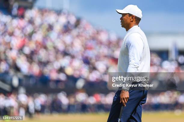 Tiger Woods walks past fans in the grandstand as he makes his way to the 18th hole during the second round of The 150th Open Championship on The Old...