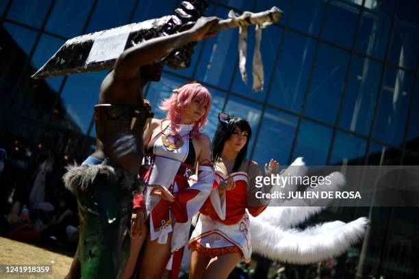 Cosplaying visitors wearing costumes of playable characters from the League of Legends game attend the Japan Expo at the Parc des Expositions in...