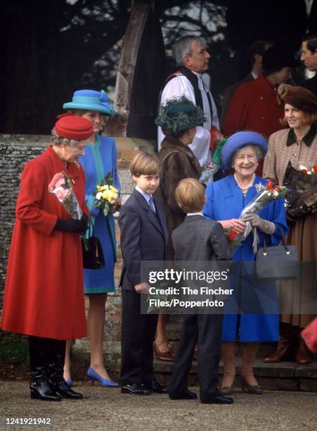 Queen Elizabeth II with other members of the Royal Family including Princess Diana, The Queen Mother, and Princes William and Harry attending a...