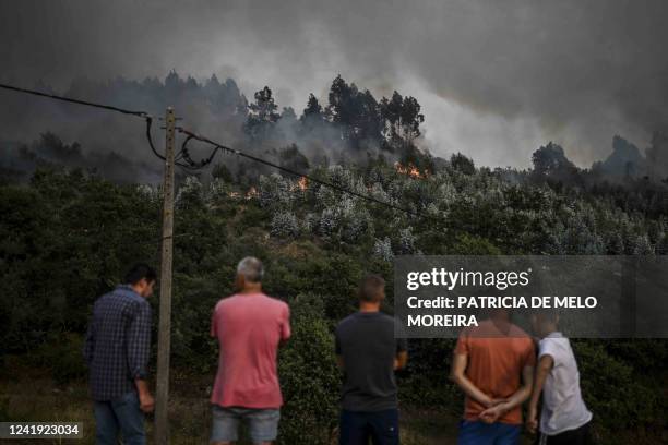 Villagers watch the progression of a wildfire at the village of Eiriz in Baiao, north of Portugal, on July 15, 2022.