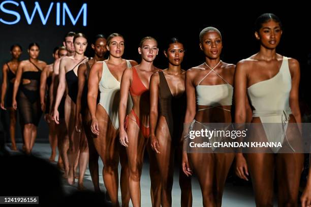 Models walk the runway showcasing "Riot Swim" designs by Monti Landers during Miami Swim Week in Miami Beach, Florida on July 15, 2022.