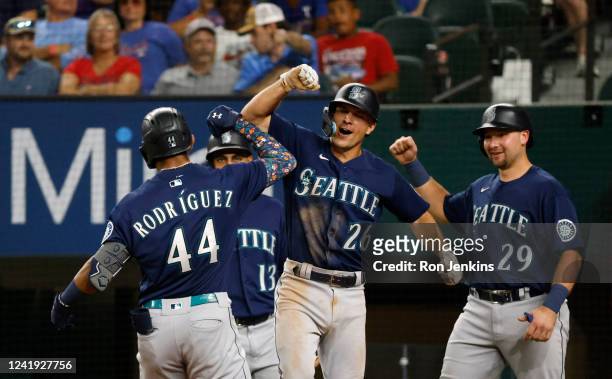 Julio Rodriguez of the Seattle Mariners celebrities with teammates Abraham Toro, Adam Frazier and Cal Raleigh after hitting a grand slam home run...