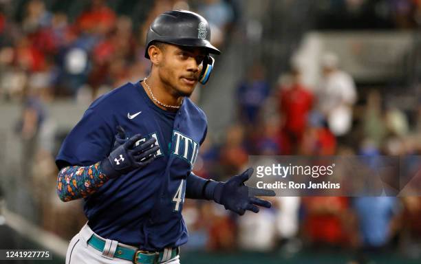 Julio Rodriguez of the Seattle Mariners runs the bases after hitting a grand slam home run against the Texas Rangers during the eighth inning at...