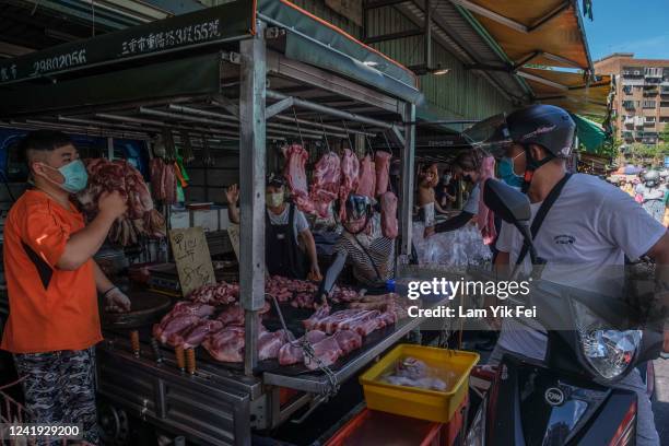 People ride on scooters to buy foods at a wet market on July 6, 2022 in Taipei, Taiwan. Taiwan has an average of 607 scooters for every 1,000 people,...