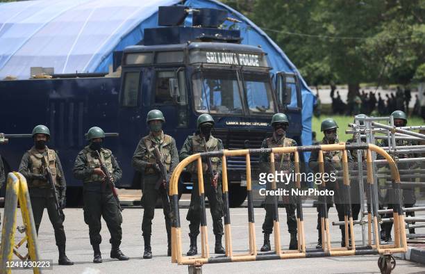 Sri Lankan army soldiers stand guard near the parliament building in Colombo on July 16, 2022.