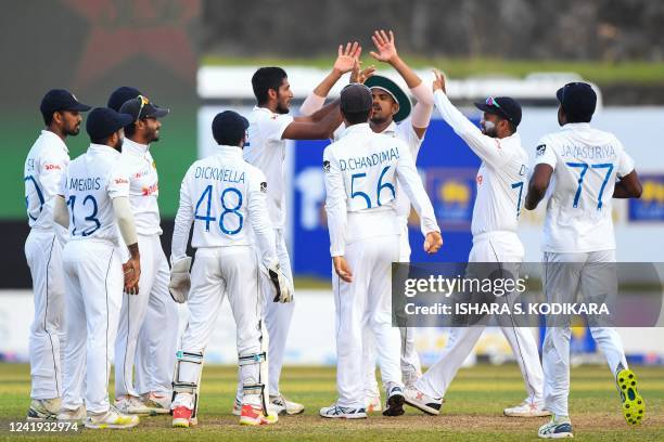 Sri Lanka's Kasun Rajitha celebrates with teammates after taking the wicket of Pakistans Imam-ul-Haq during the first of day play of the first...