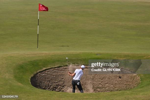 Golfer Justin Thomas plays out of a greenside bunker on the 11th during his third round on day 3 of The 150th British Open Golf Championship on The...