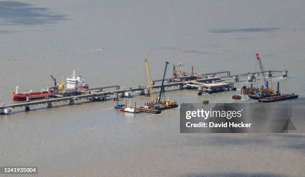 In this view from an airplane a terminal for connecting floating stations for liquified natural gas stands under construction on July16, 2022 near...
