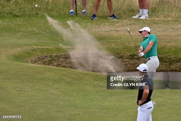 Northern Ireland's Rory McIlroy holes this bunker shot for an eagle on the 10th hole during his third round on day 3 of The 150th British Open Golf...