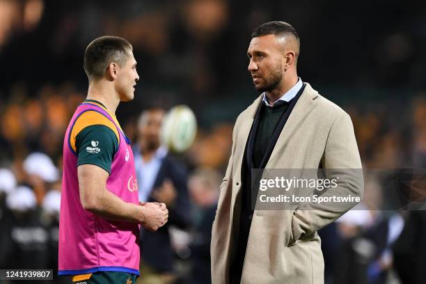 Injured Wallaby Quade Cooper talks to James O'Connor before the rugby international test match between Australia Wallabies and England at The Sydney...