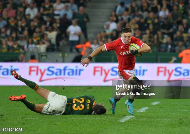 Josh Adams of Wales gets past Willie le Roux of South Africa during the 3rd Castle Lager Incoming Series test match between South Africa and Wales at...