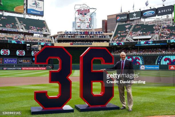 Former Minnesota Twins pitcher Jim Kaat poses for a photo with a display during his number retirement ceremony before the start of the game between...