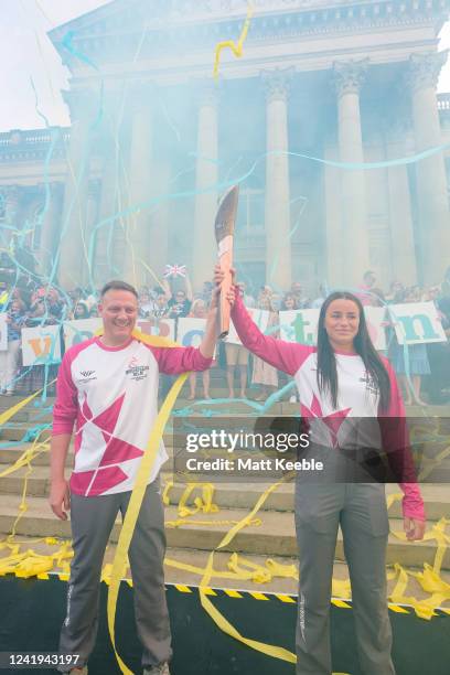 Antony Cotton and Kelsey Barnes take part in The Queen's Baton Relay as part of the Birmingham 2022 Queens Baton Relay on July 16, 2022 in Bolton,...