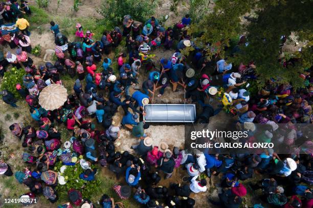 In this aerial vewi indigenous people bury the coffin of Melvin Guachiac, a 13-year-old Guatemalan teenager who was killed inside a tractor-trailer...