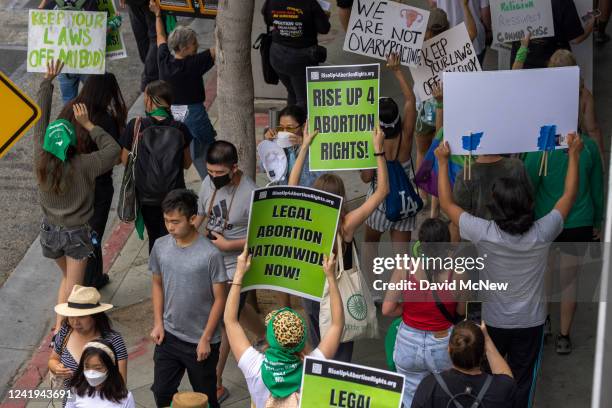 Passersby find themselves in the middle of a protest march to a Planned Parenthood office, which was targeted by Proud Boys and an anti-abortion...