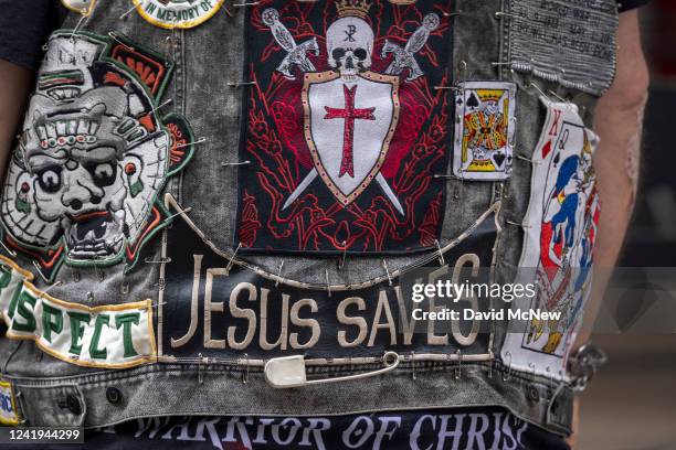 Man wears a vest with religious messages on it as protesters march to a Planned Parenthood office, which was targeted by Proud Boys and an...