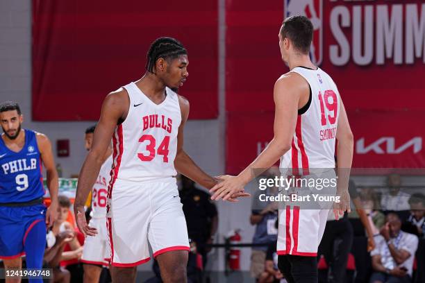 Justin Lewis of the Chicago Bulls high fives Marko Simonovic of the Chicago Bulls during the game against the Philadelphia 76ers during the 2022 Las...