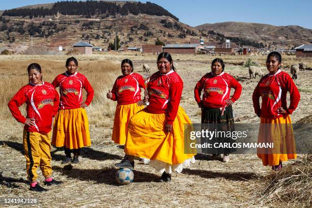 Football team of Aymara indigenous women pose for a picture before a championship in the Aymara district of Juli in Puno, southern Peru, on July 16,...