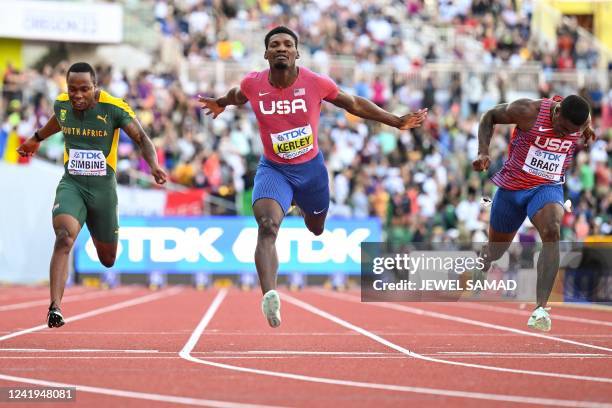 South Africa's Akani Simbine USA's Fred Kerley and USA's Marvin Bracy cross the finish line in the men's 100m final during the World Athletics...