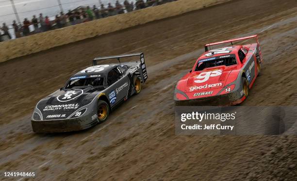 Ernie Francis Jr, driver of and Tony Stewart, driver of, drive during a heat race at a Camping World Superstar Racing Experience at I-55 Raceway on...