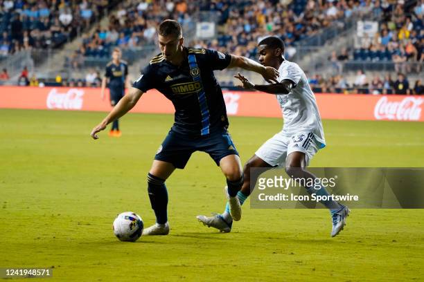 Philadelphia Union Forward Mikael Uhre and New England Revolution Midfielder Lucas Maciel Felix battle for the ball during the second half of the...