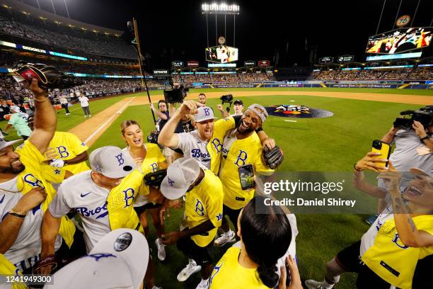 The Brooklyn Team celebrates after defeating the Los Angeles Team in the MGM All-Star Celebrity Softball Game at Dodger Stadium on Saturday, July 16,...