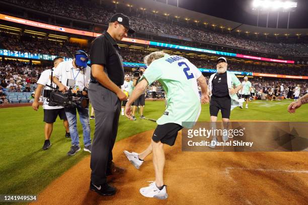 Bryan Cranston kicks dirt on the umpire during the MGM All-Star Celebrity Softball Game at Dodger Stadium on Saturday, July 16, 2022 in Los Angeles,...