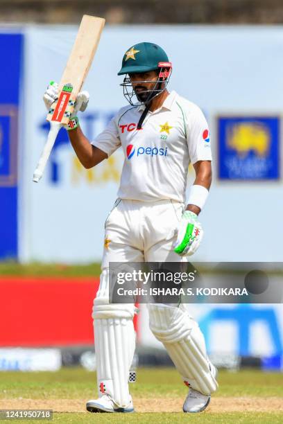 Pakistan's Babar Azam celebrates after scoring a half-century during the second day of the first cricket Test match between Sri Lanka and Pakistan at...