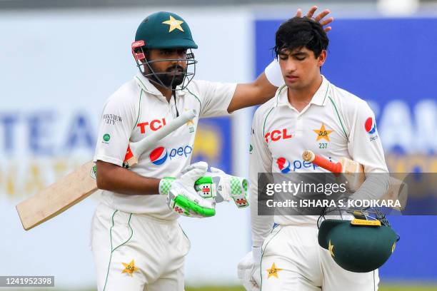 Pakistan's captain Babar Azam and teammate Naseem Shah walk back to the pavilion for a tea break during the second day of the first cricket Test...