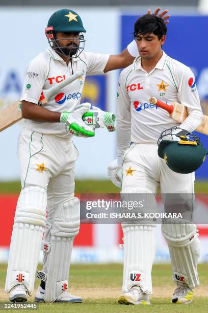 Pakistans captain Babar Azam and teammate Naseem Shah walk back to the pavilion for a tea break during the second day of the first cricket Test match...