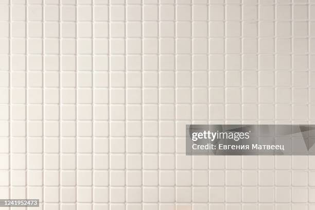 white mosaic tiles wall abstract background texture. close up. selective focus. copy space. - tile imagens e fotografias de stock
