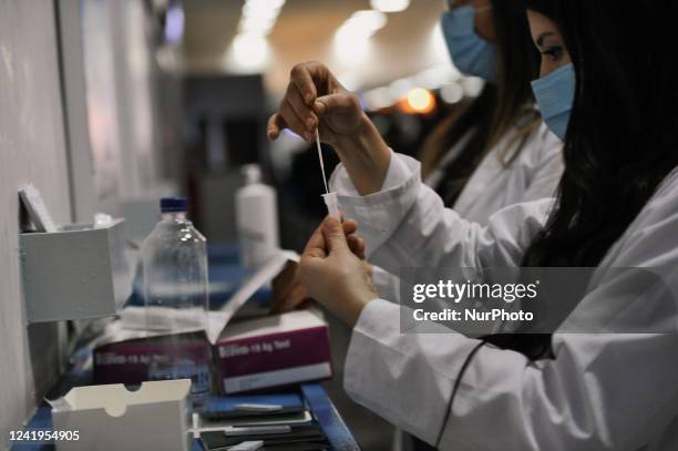 Nurse analyzes Covid-19 tests and reveals the result to the patient at Charles Nicole Hospital in Tunis,Tunisia on July 17,2022.