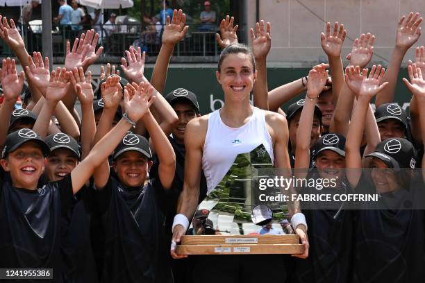 Croatia's Petra Martic holds the trophy as she poses with the ball boys after winning her final match against Serbia's Olga Danilovic at the Ladies...