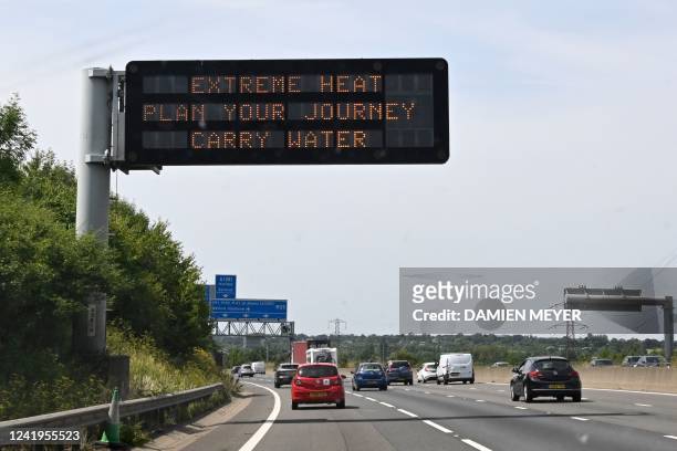 Road sign reads "Extreme Heat, Plan your journey, Carry water", warning motorists about the heatwave forecast for July 18 and 19, on the M11 motorway...