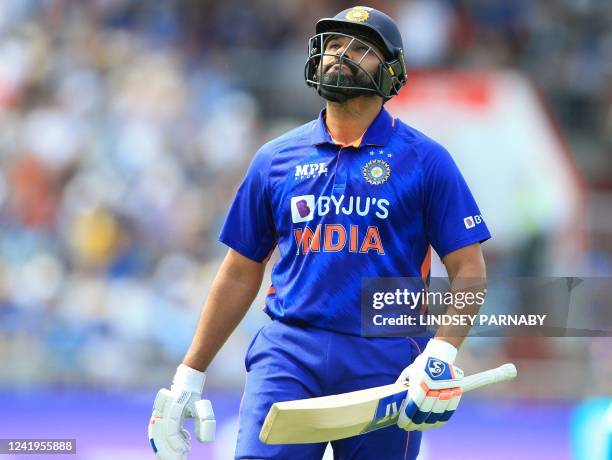 India's captain Rohit Sharma walks back to the pavilion after losing his wicket for 17 runs during the final one-day international cricket match...